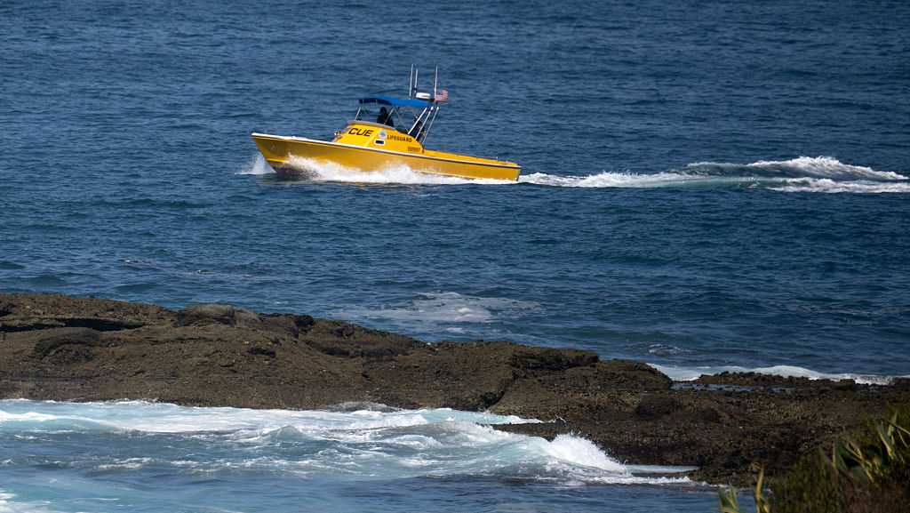 Authorities search for a girl swept into the ocean in Southern California