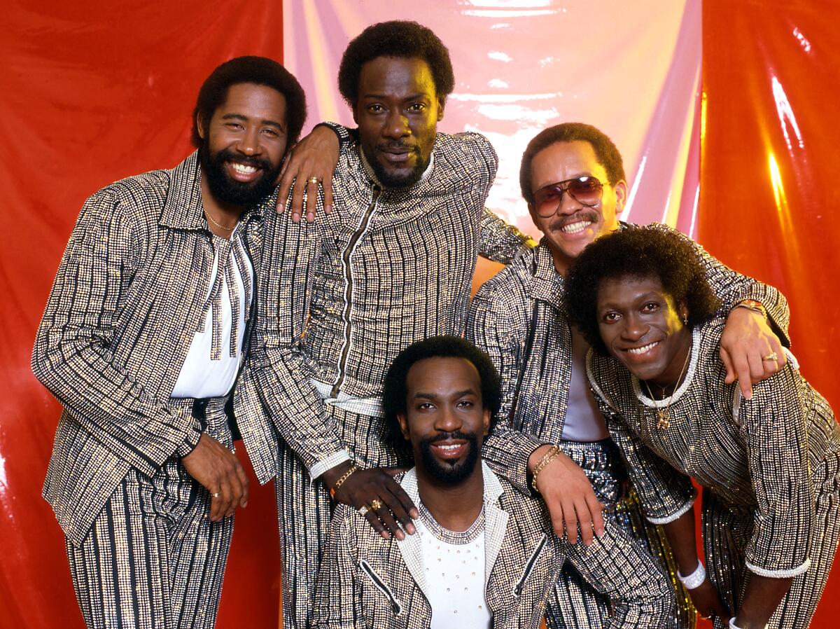 Thomas McClary, Milan Williams, William King, Ronald LaPread and Walter Orange, wearing coordinated looks, smile in 1986.