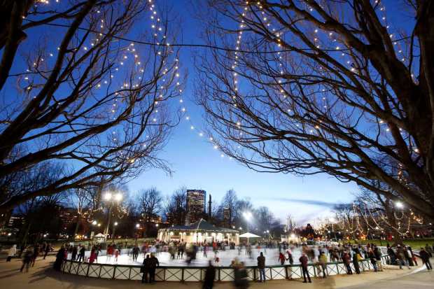 People skate on an ice rink on Boston Common in Boston, on Christmas Eve, Monday, Dec. 24, 2012.