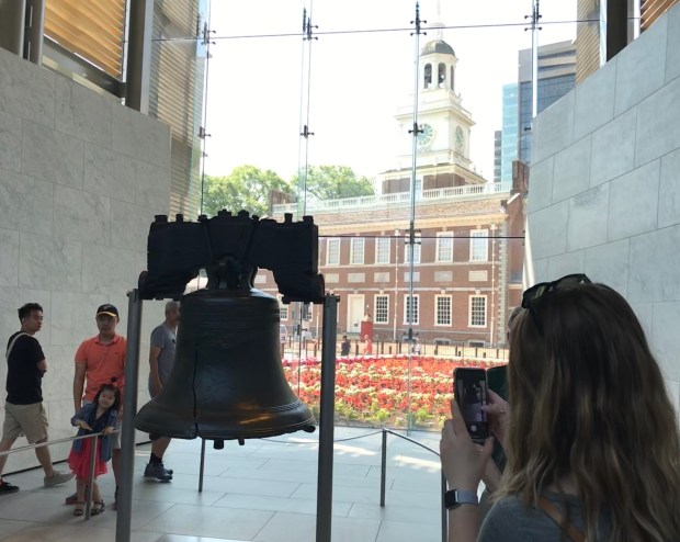 Indpendence Hall is visible behind the Liberty Bell in Philadelphia. (Photo by David Allen)