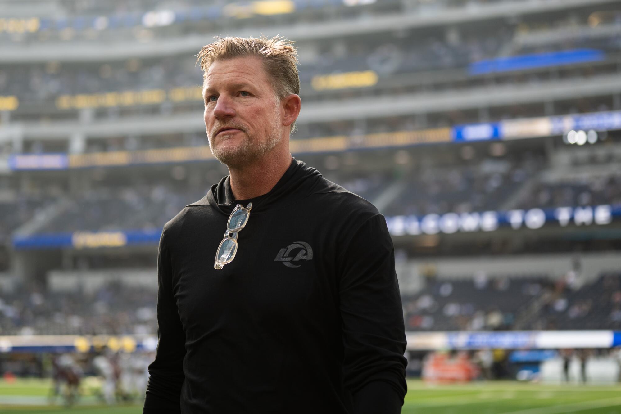Rams general manager Les Snead walks on the field before a game between the Rams and New Orleans Saints.