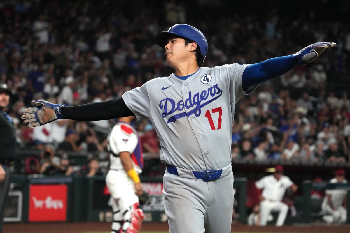 Shohei Ohtani reacts after scoring on a single by Mookie Betts in the seventh inning,