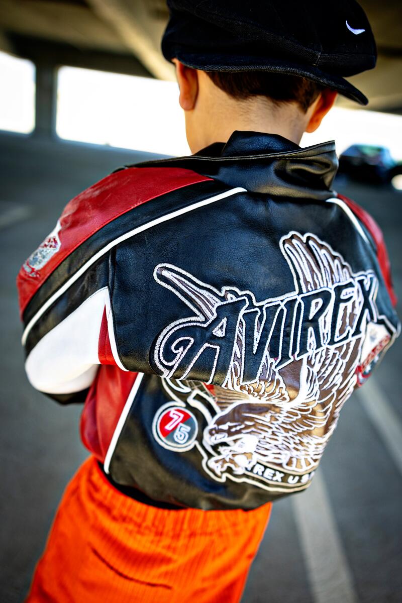 A child wearing an Avirex jacket from the ’90s.