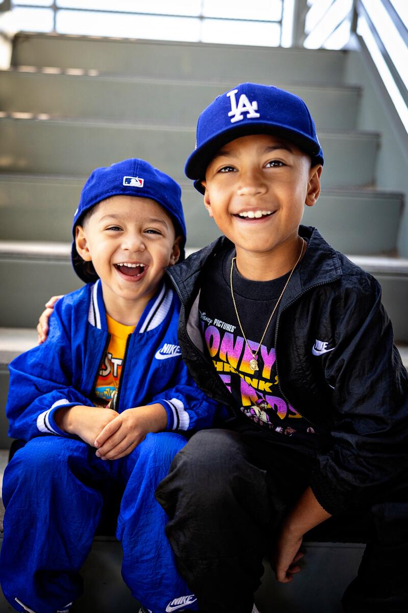 Brothers pose for a portrait wearing vintage clothing.