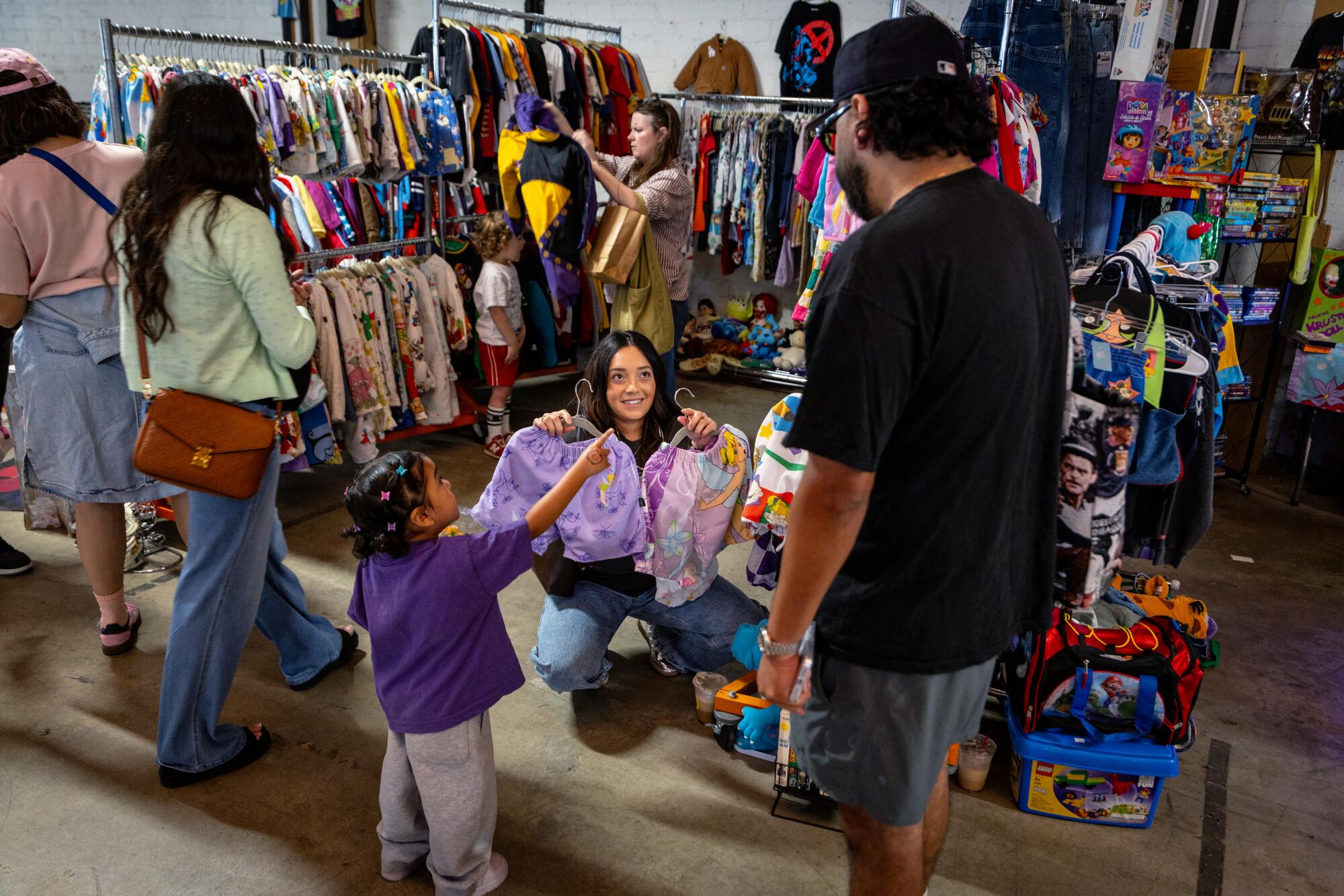 Jackie and Frank Oropeza with daughter Rumi Mae shop at Elemeno Kids Vintage Market.