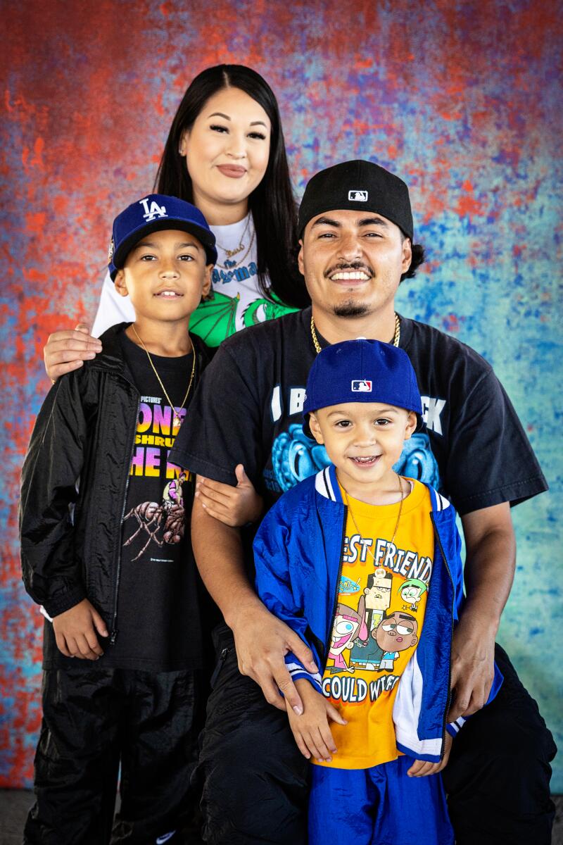 A family poses for a portrait wearing vintage clothing.