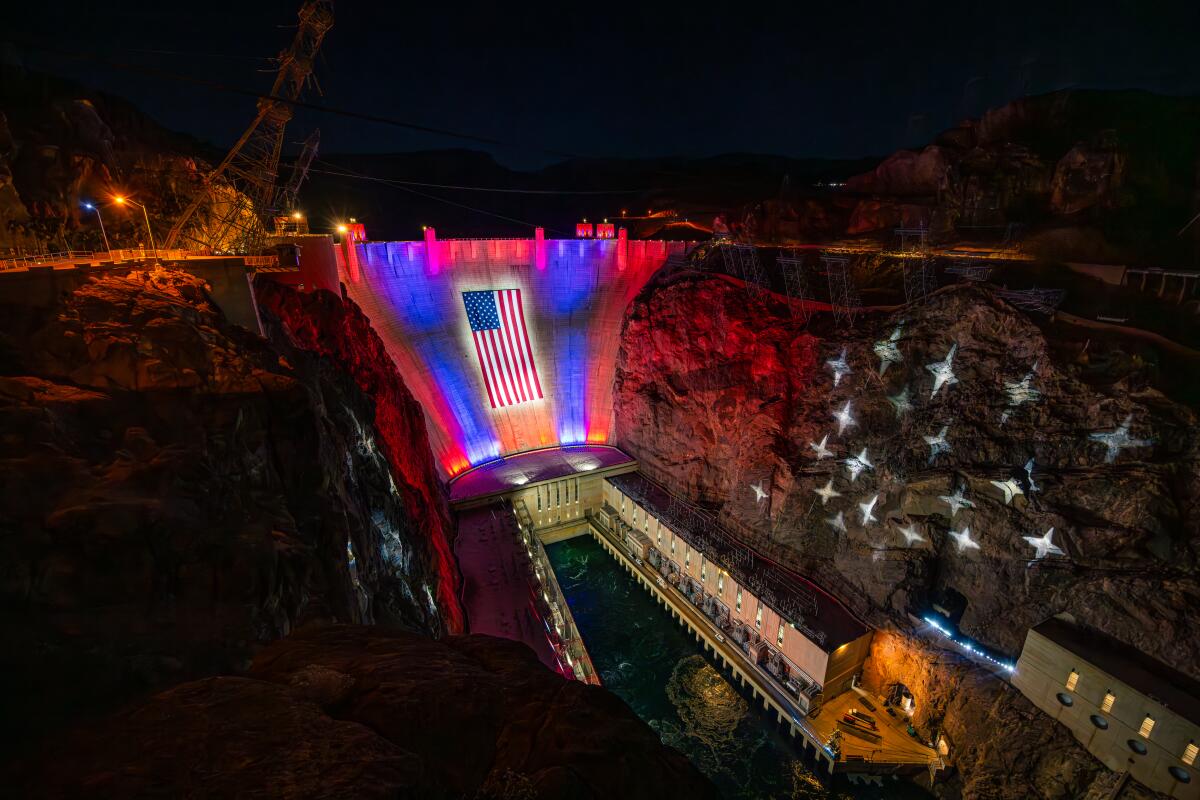 Hoover Dam is decorated with a big, lighted American flag to salute the nation's 250th anniversary of independence. 