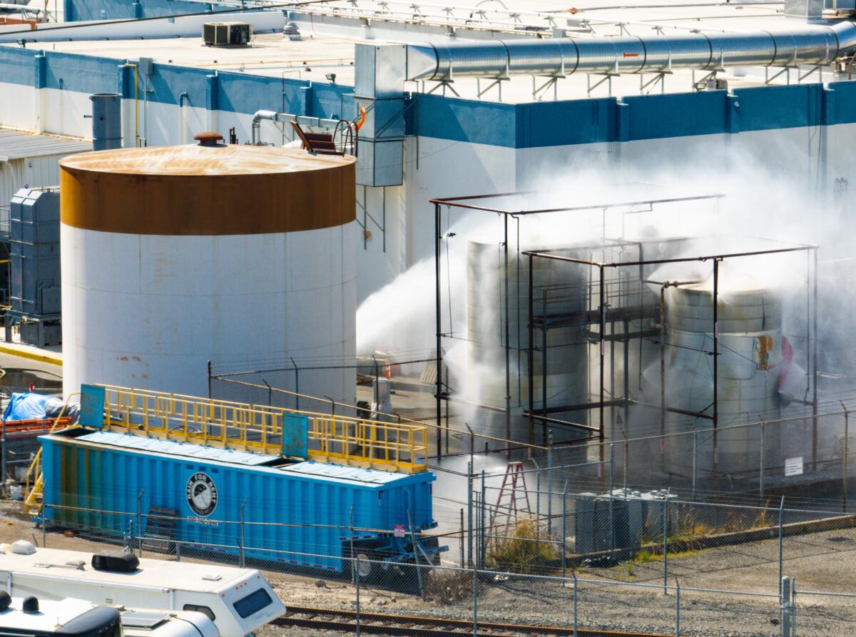  An aerial of water being sprayed on large storage tanks at the GKN Aerospace facility on  May 24 in Garden Grove.