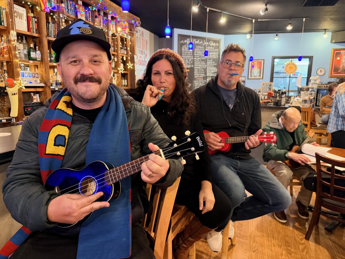 Moses Nolf, left, with friends at a ukulele and kazoo playing session in Michigan last November. 
