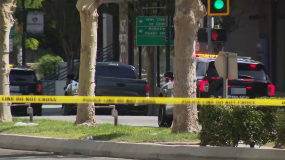 Police tape blocks access to a downtown Bakersfield street near a Chase Bank building as law enforcement responds to a reported bomb threat and standoff.
