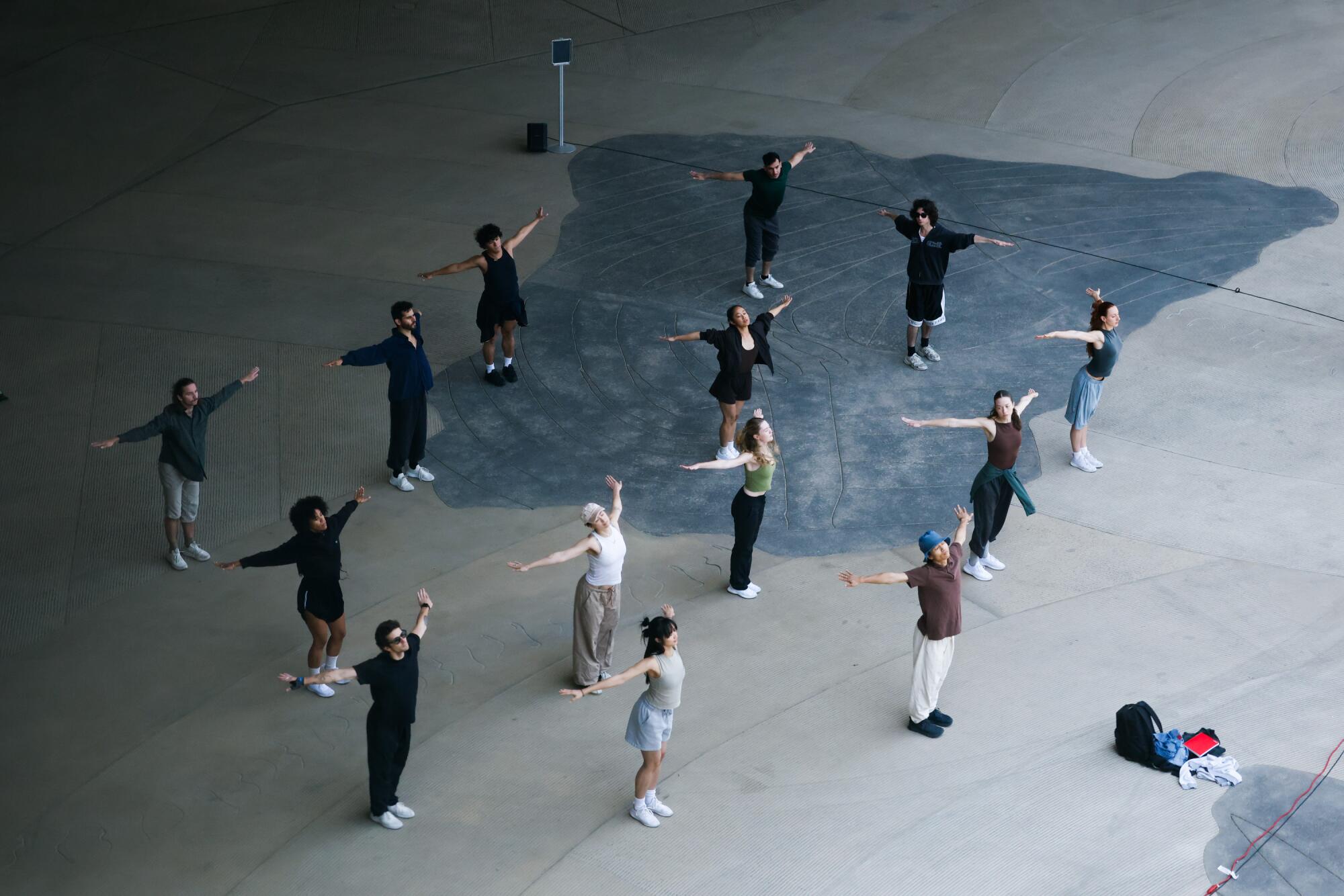 Dancers from above on a concrete floor.