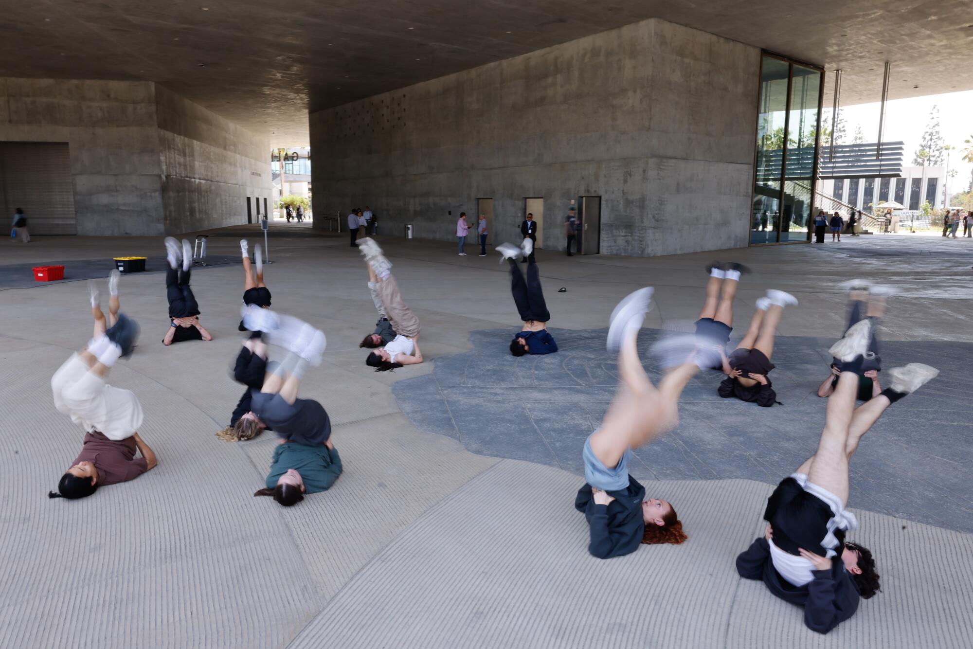 Dancers perform outdoors at a museum.