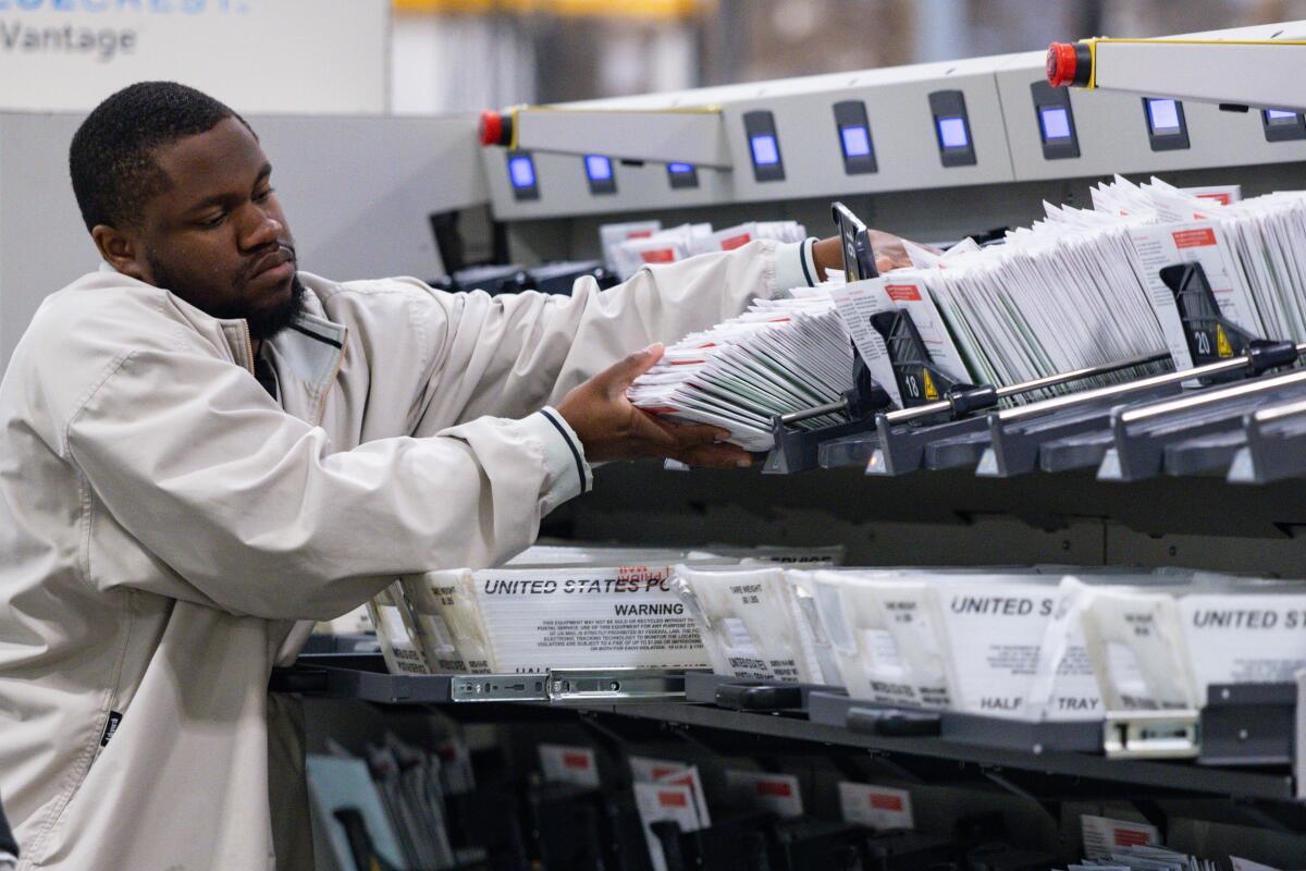 A worker counts ballots