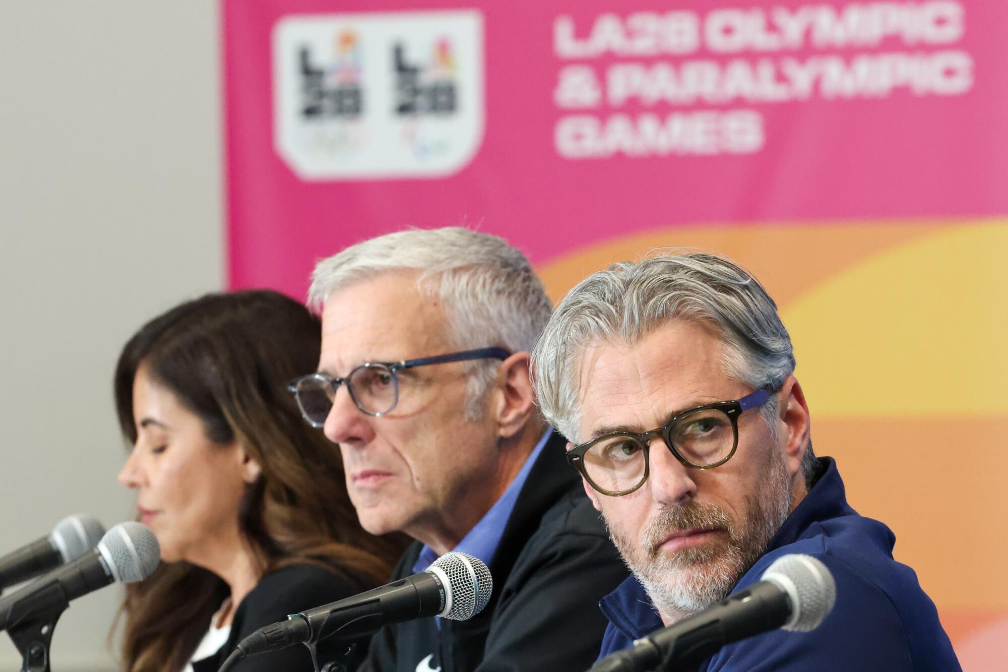 LA28 chairman Casey Wasserman, right, sits next to Reynold Hoover, LA28 CEO (center) and Jacie Prieto Lopez.