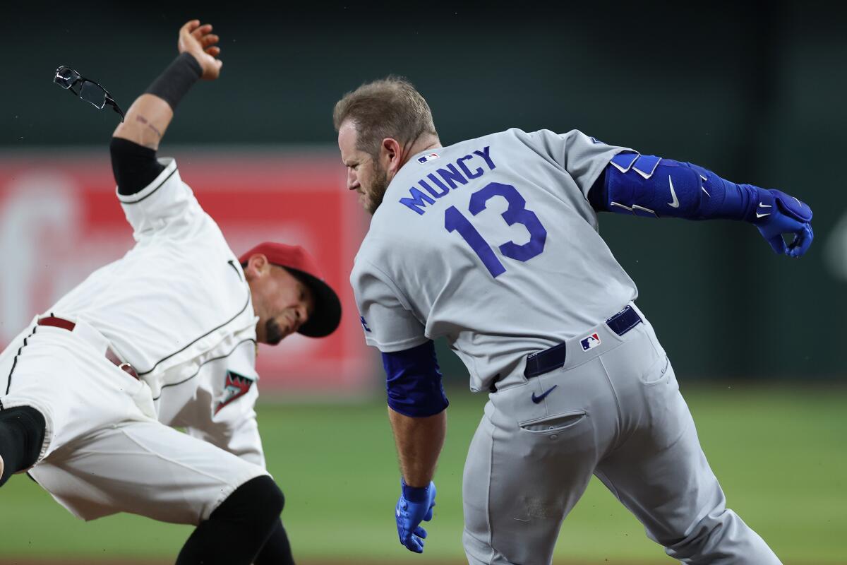 Max Muncy collides with Diamondbacks first baseman Ildemaro Vargas during the fifth inning Thursday.