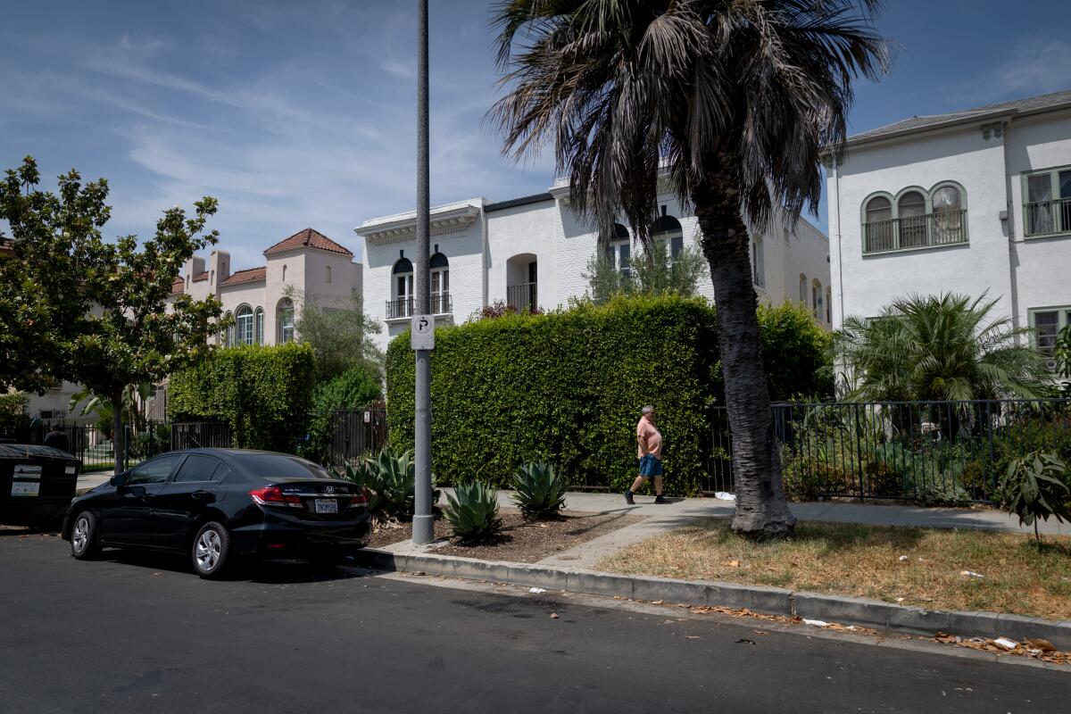 A man walks in front of an apartment complex on Berendo Street in Koreatown on Wednesday.