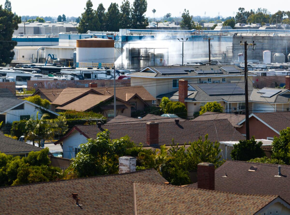An aerial of water being sprayed on large storage tanks