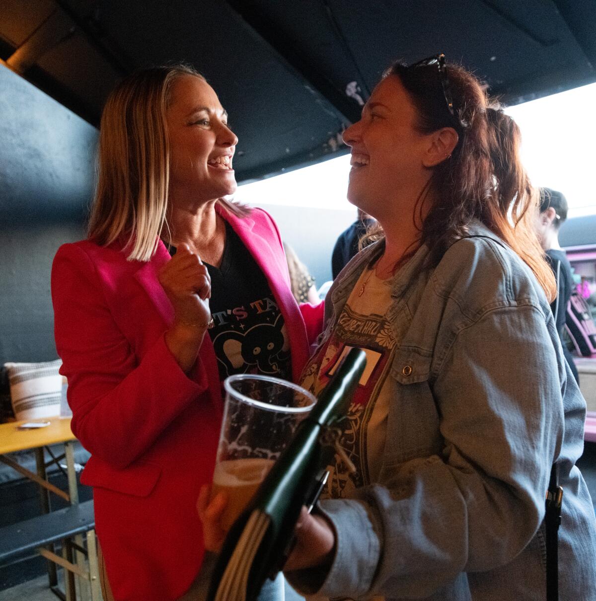 Lisa Pahl, left, a hospice social worker and co-creator of the Death Deck, mingles with an attendee at Death over Drafts.