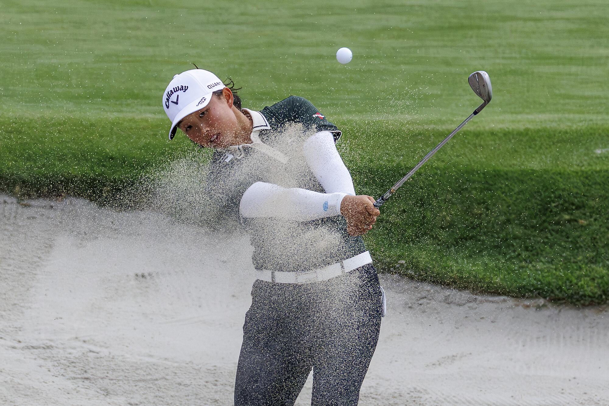 Ruoning Yin hits out of a green side bunker on No. 17 during the second round of the U.S. Women's Open.