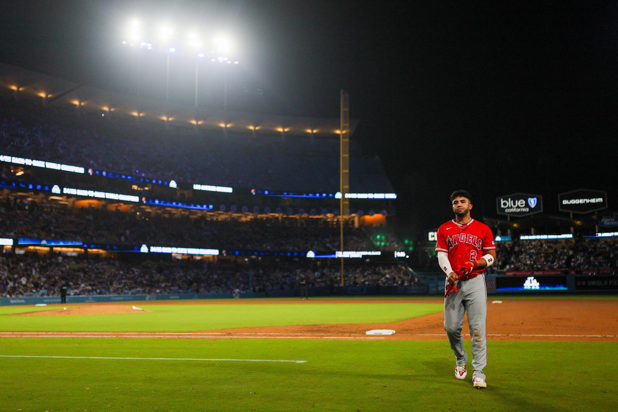 Angels second baseman Oswald Peraza walks back to the dugout after grounding out during the ninth inning against the Dodgers.