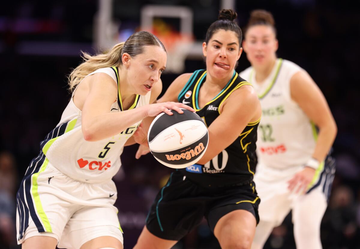 Dallas guard Paige Bueckers controls the ball in front of Sparks guard Kelsey Plum during the second half Friday.