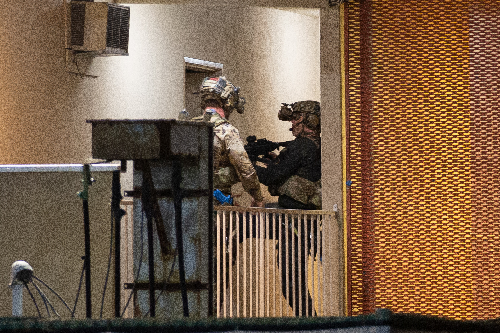 Soldiers kick down a door during a training exercise at...
