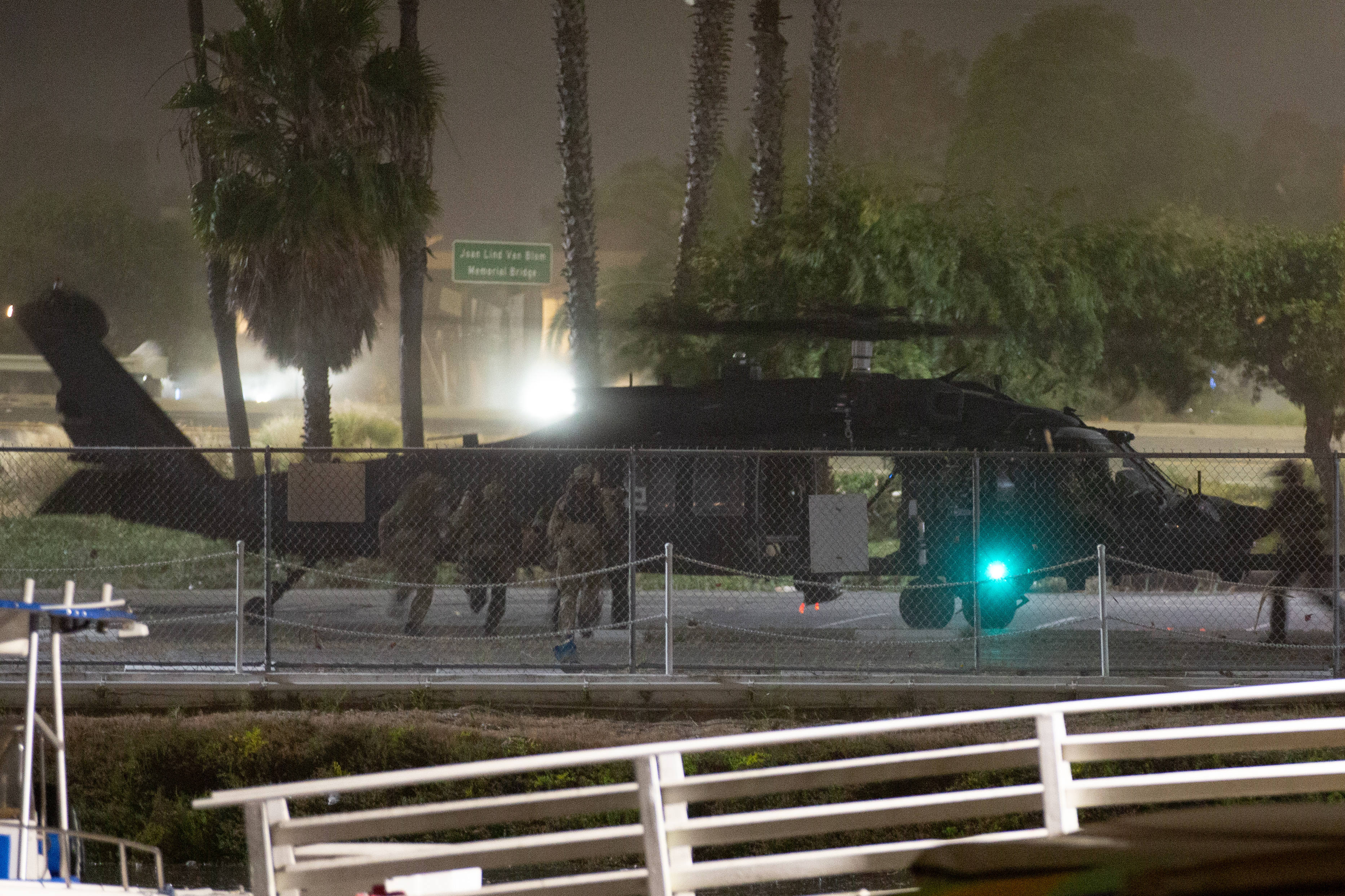 A US Army Blackhawk helicopter lands to pick up a...