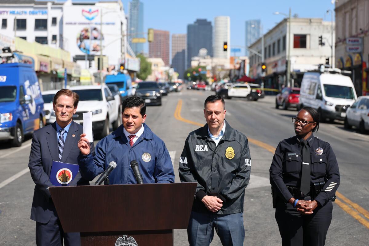 Bill Essayli, second from left, speaks during a news conference