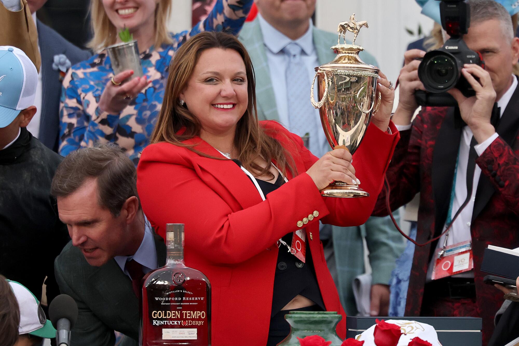 Golden Tempo's trainer Cherie DeVaux kisses a trophy after winning the Kentucky Derby.