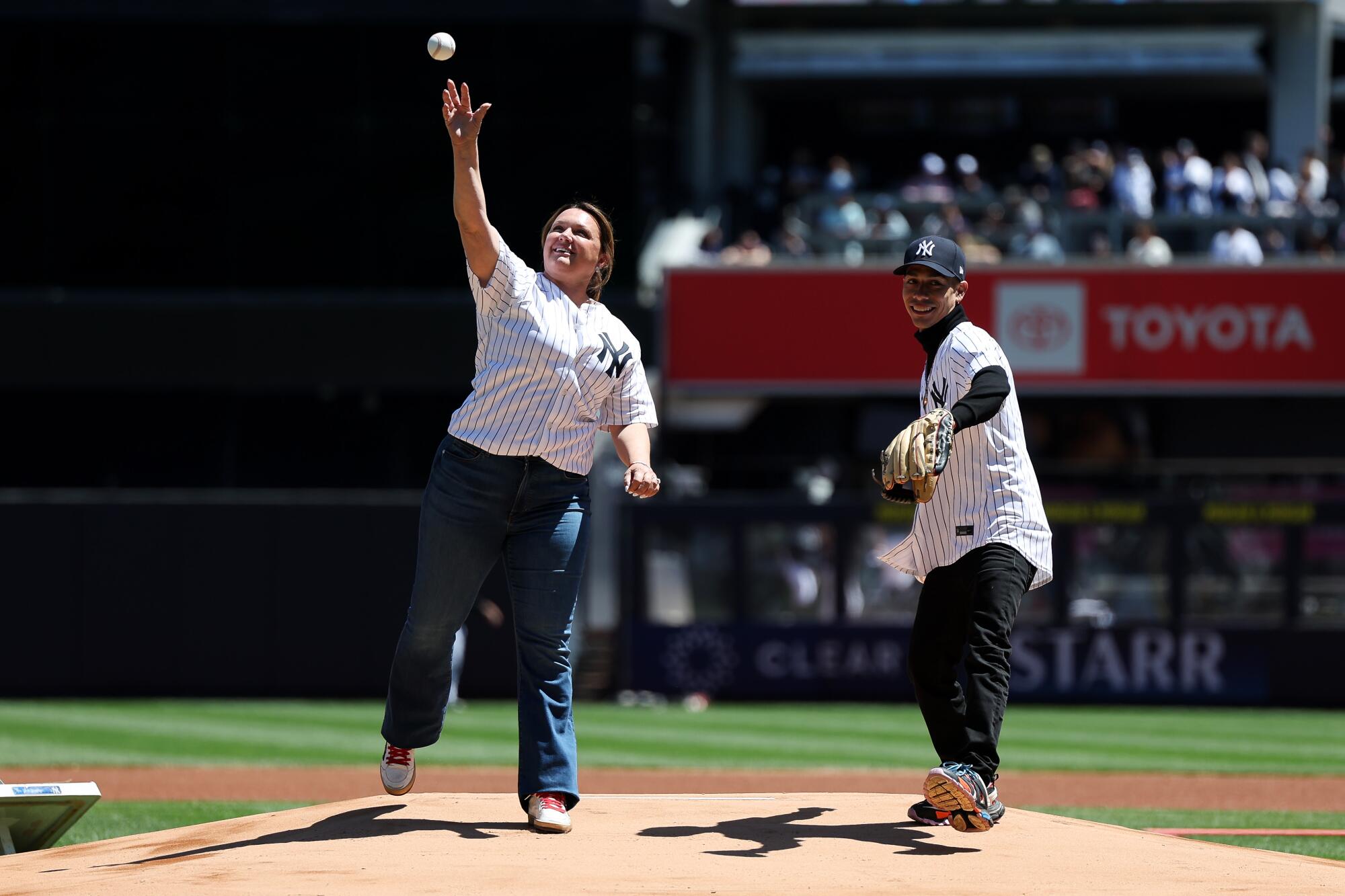 Kentucky Derby winning trainer Cherie DeVaux and jockey Jose Ortiz throw out the first pitch at Yankee Stadium on May 7.
