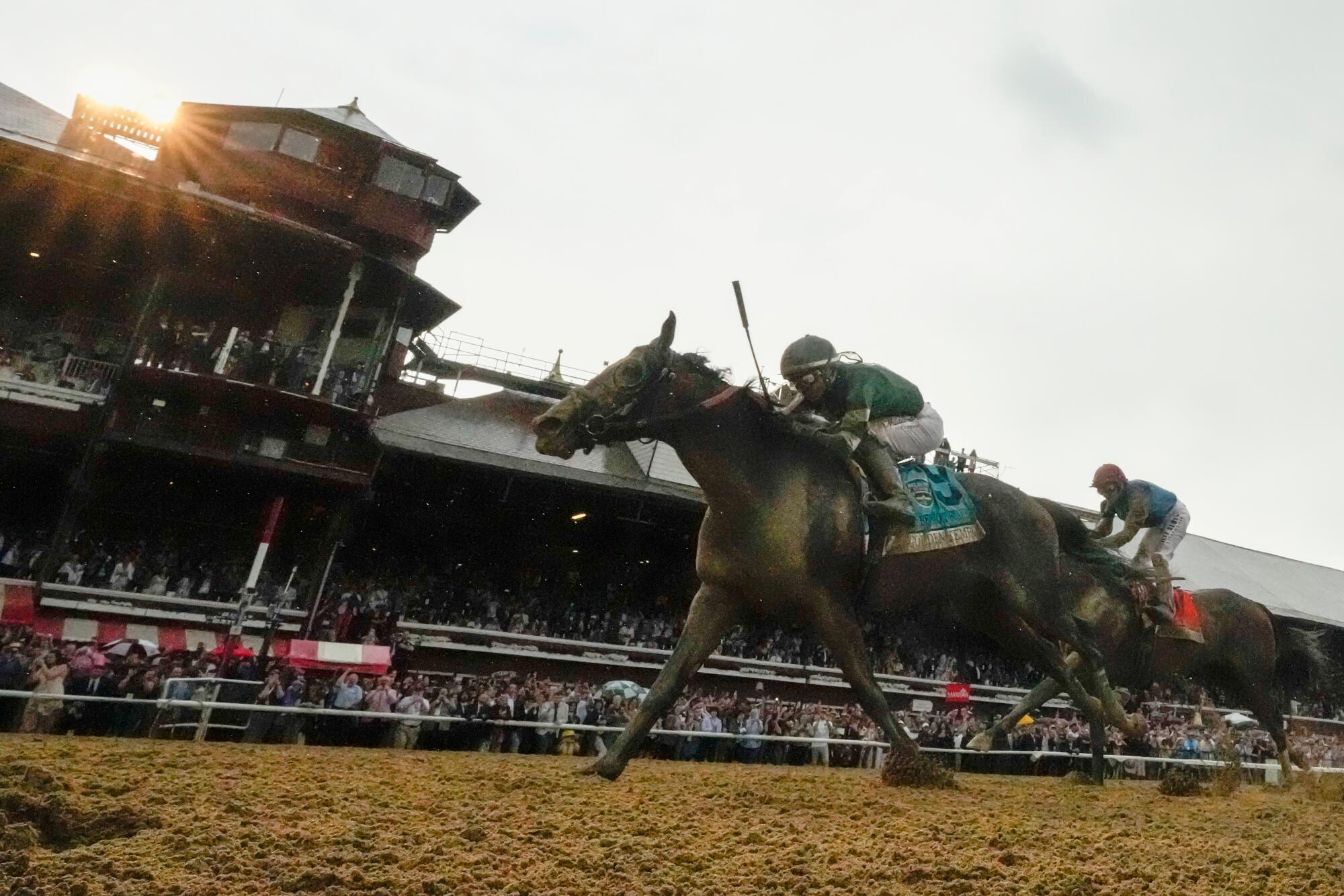 Golden Tempo, ridden by jockey Jose Ortiz, crosses the finish line to win the Belmont Stakes on Saturday.