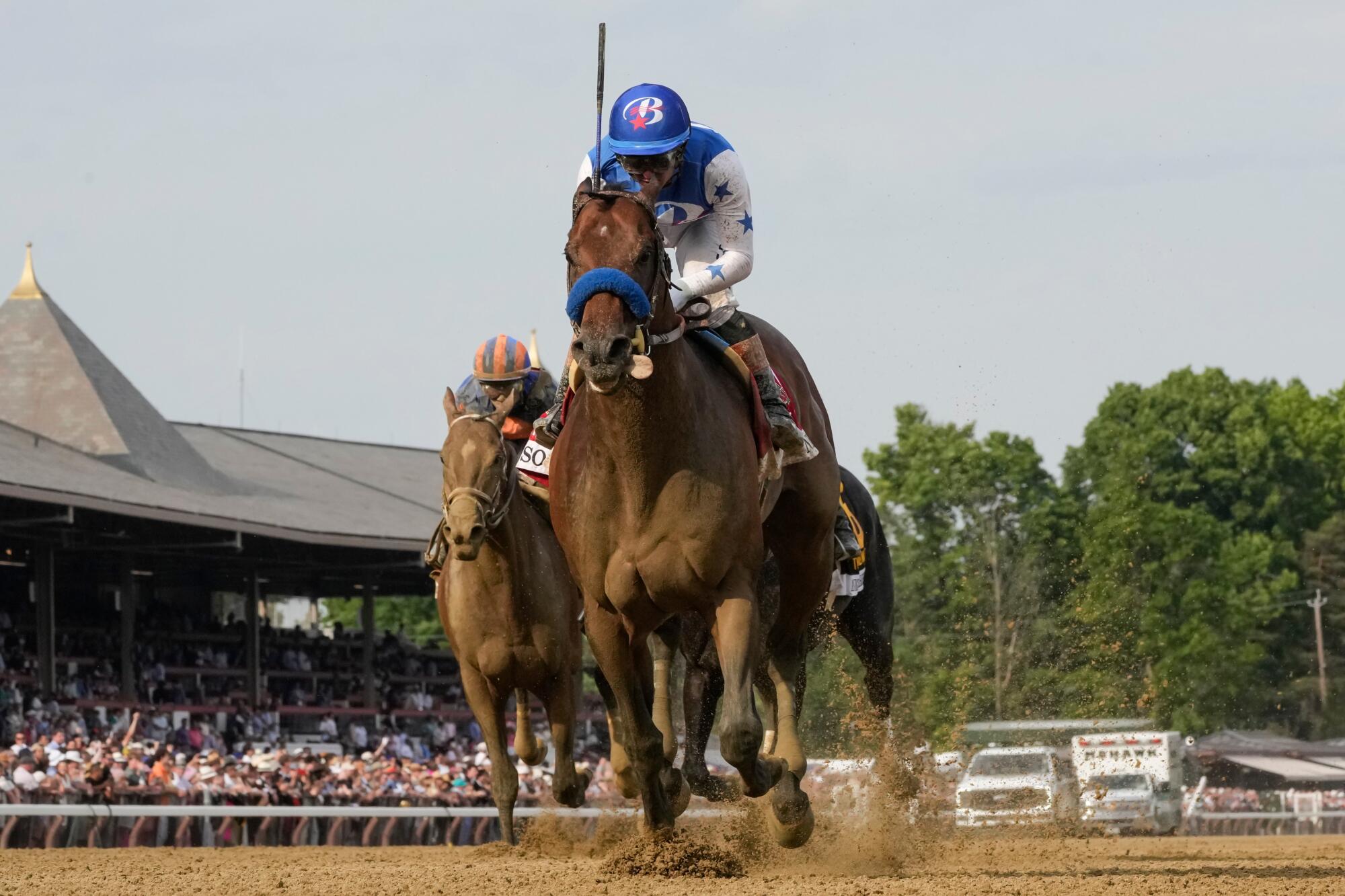 Nysos crosses the finish line to win the 133rd running of the Met Mile at Saratoga on Saturday.