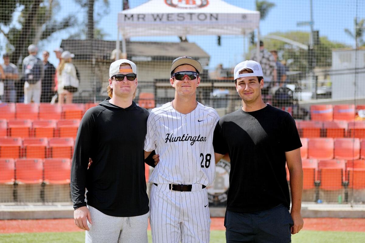 Jared Grindlinger, center, stands with his older brothers Trent, left, and Bradley.