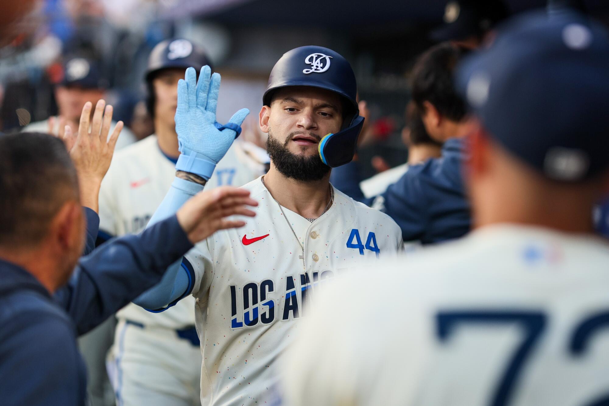 Andy Pages celebrates with teammates in the dugout after hitting a two-run home run.