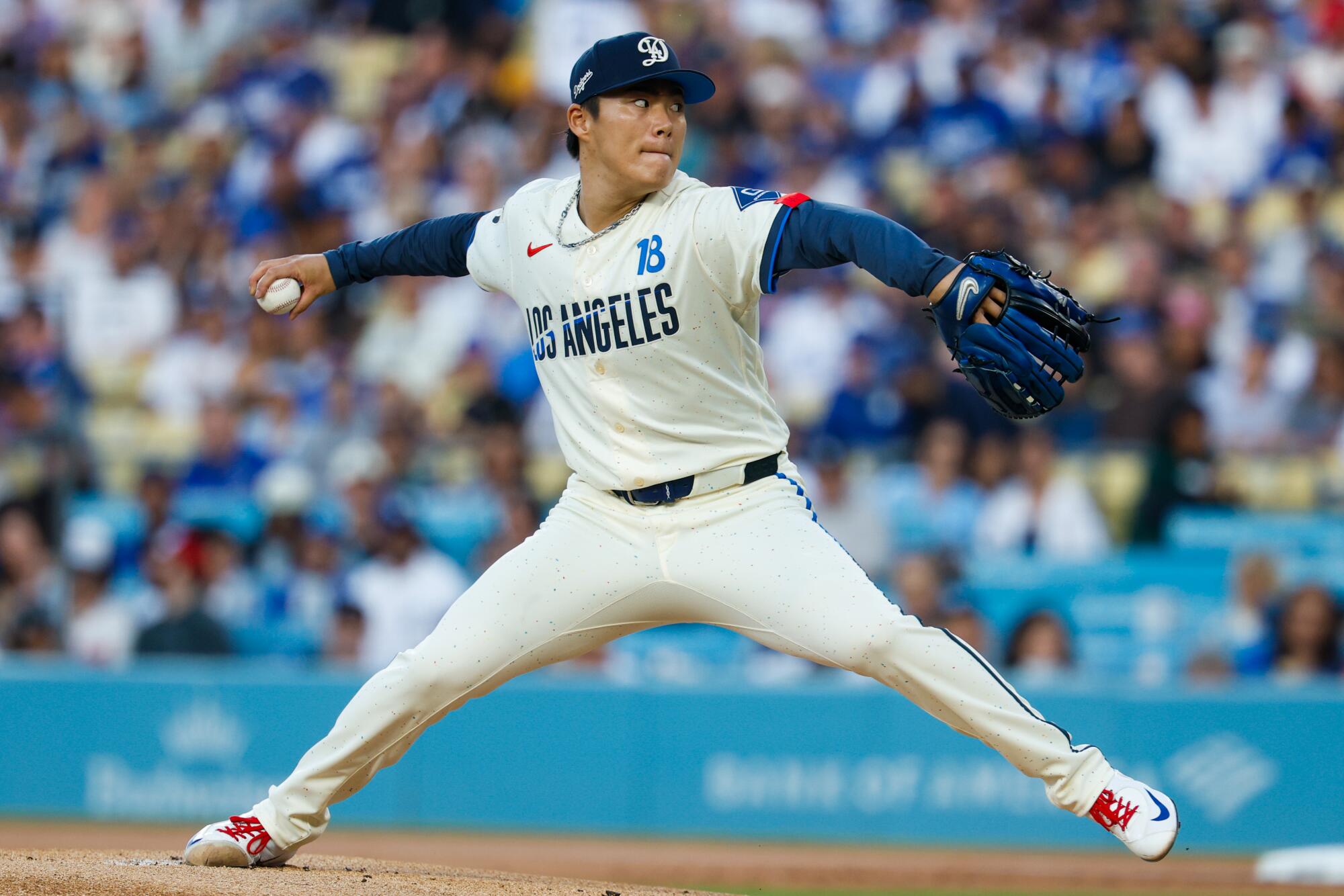 Dodgers pitcher Yoshinobu Yamamoto delivers against the Angels in the first inning Saturday at Dodger Stadium.