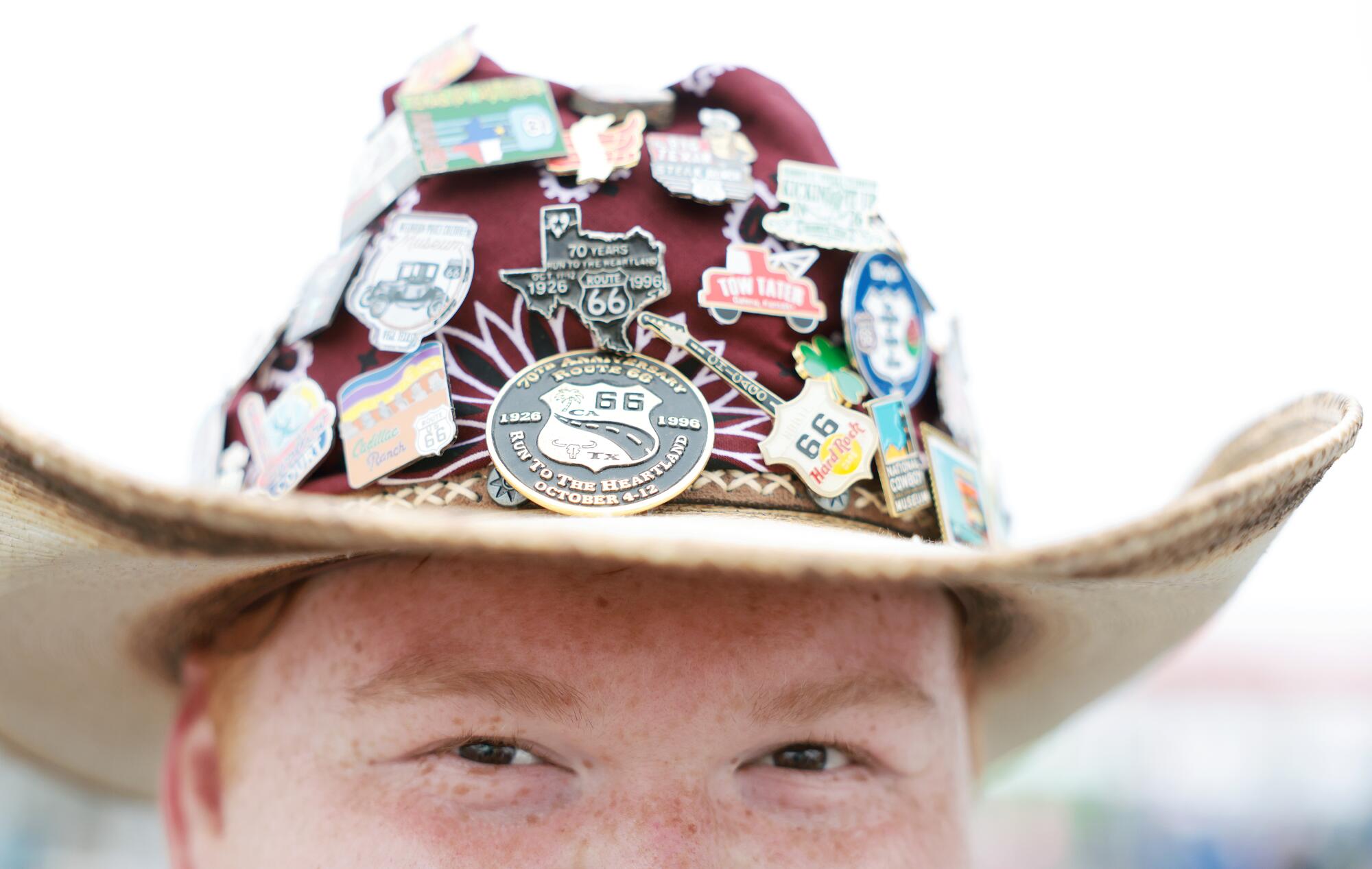 Detail of a person in a cowboy hat with pins
