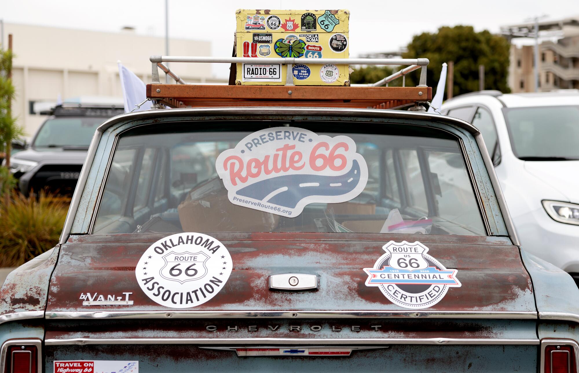 A participant's vehicle in a caravan with stickers in the rear window. One says Preserve Route 66