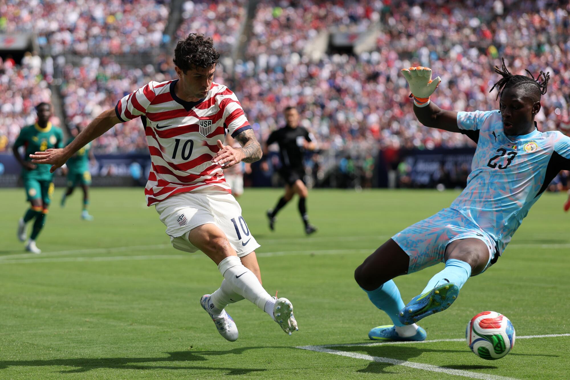 Christian Pulisic scores past Senegal goalkeeper Mory Diaw during an international friendly match on May 31.