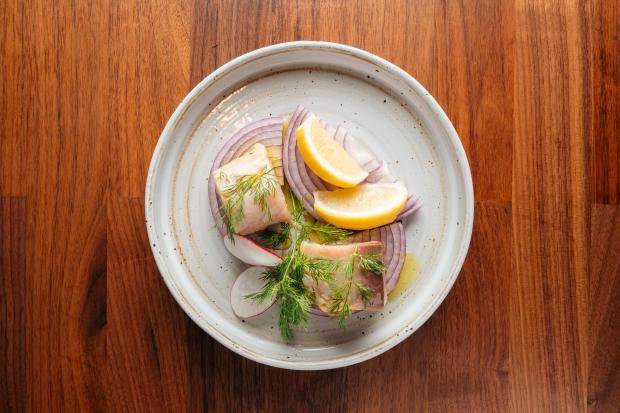 Lakerda, a dish of preserved bonito, red onion, dill, lemon and olive oil, is served in May 2026 at the Turkish restaurant Meyhouse, which has multiple locations in the San Francisco Bay Area. (Emre Cakir)