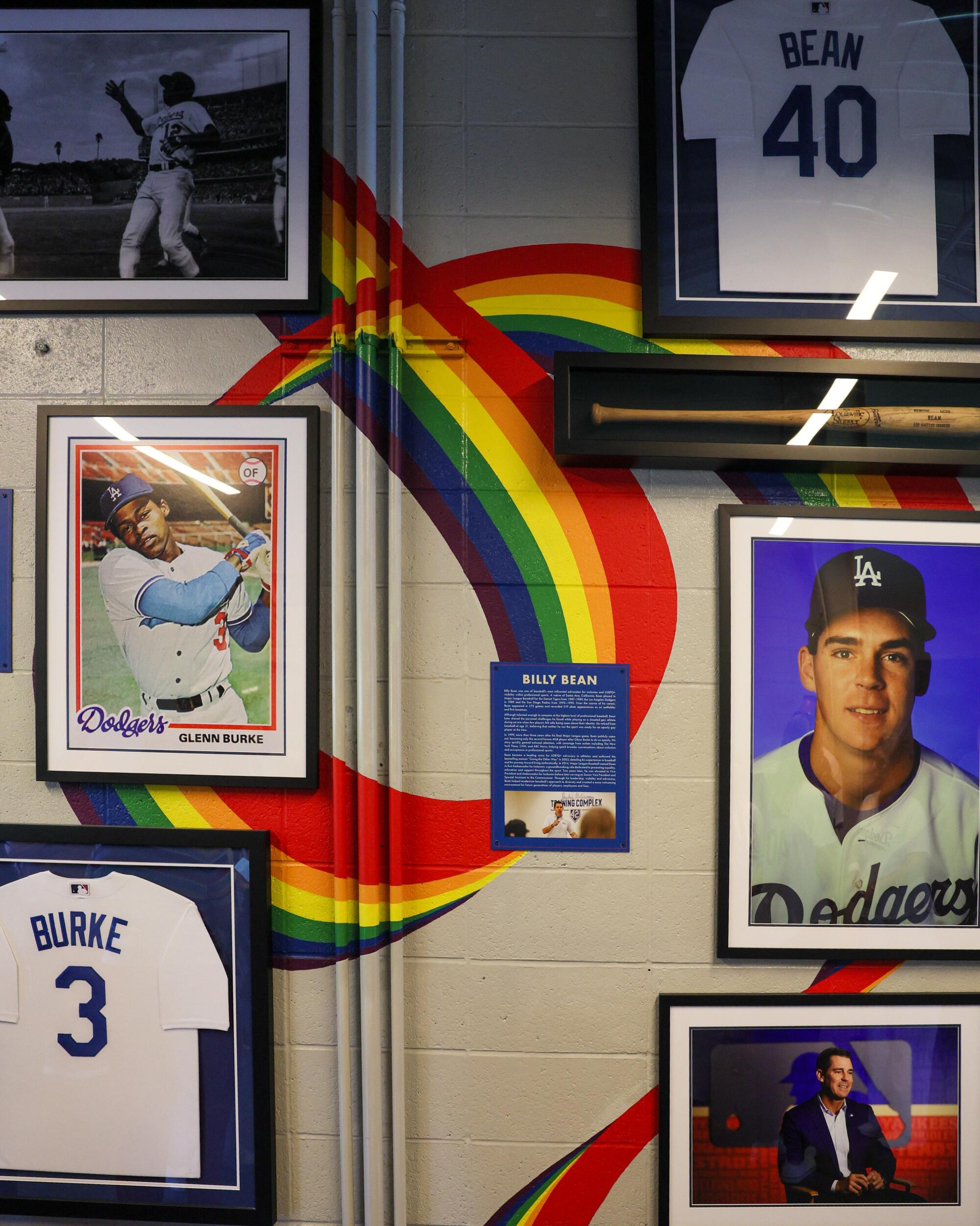 A wall inside Dodger Stadium features photos honoring former Dodgers and LGBTQ+ pioneers Billy Bean and Glenn Burke.