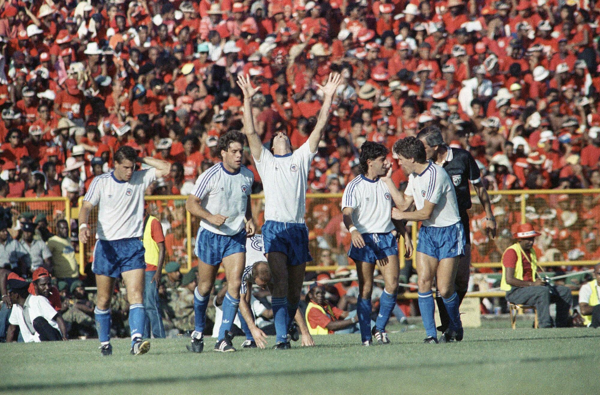 U.S. players react after Paul Caligiuri, second from left, scored against Trinidad and Tobago.