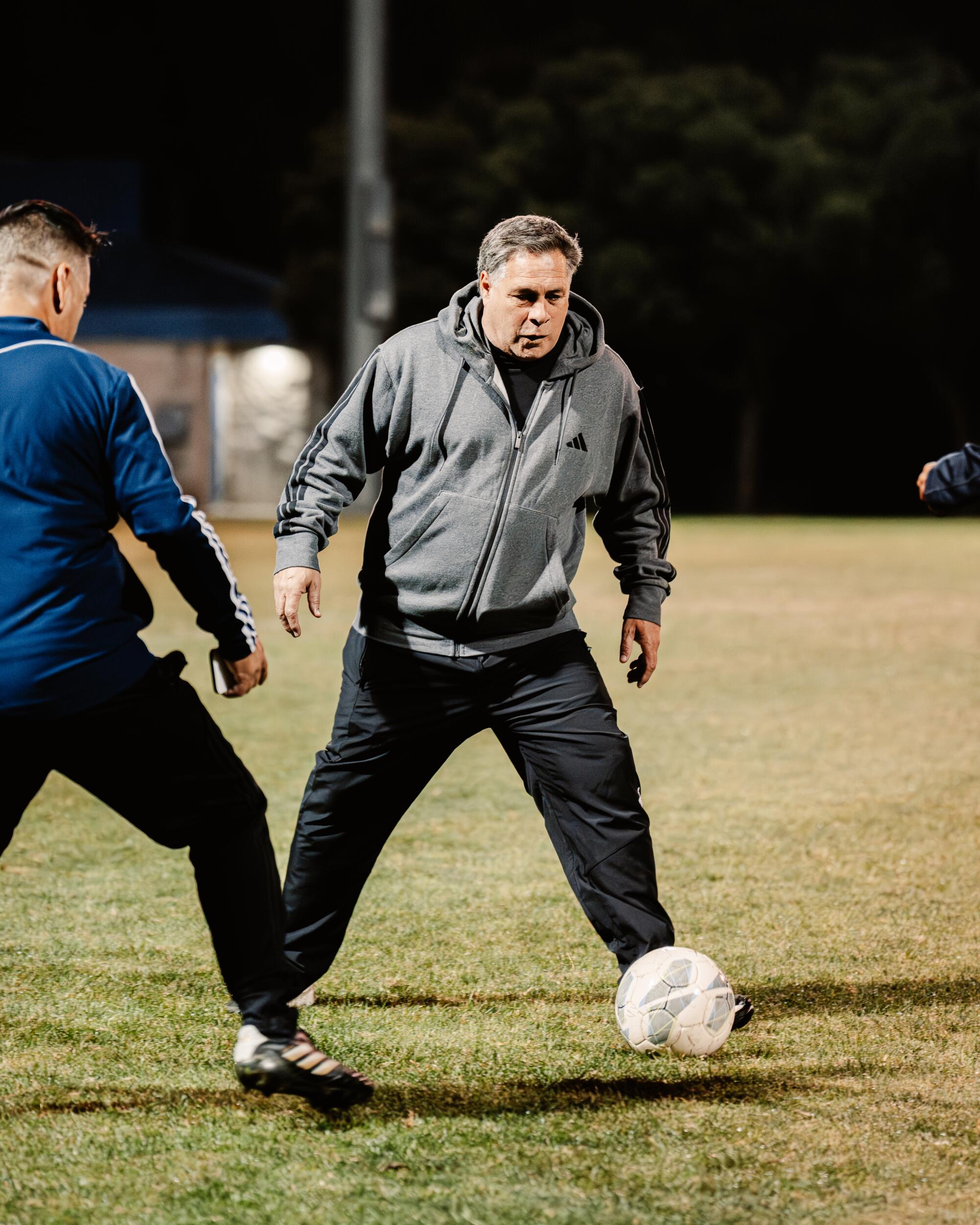 Paul Caligiuri controls the ball during a recent practice with youth players.