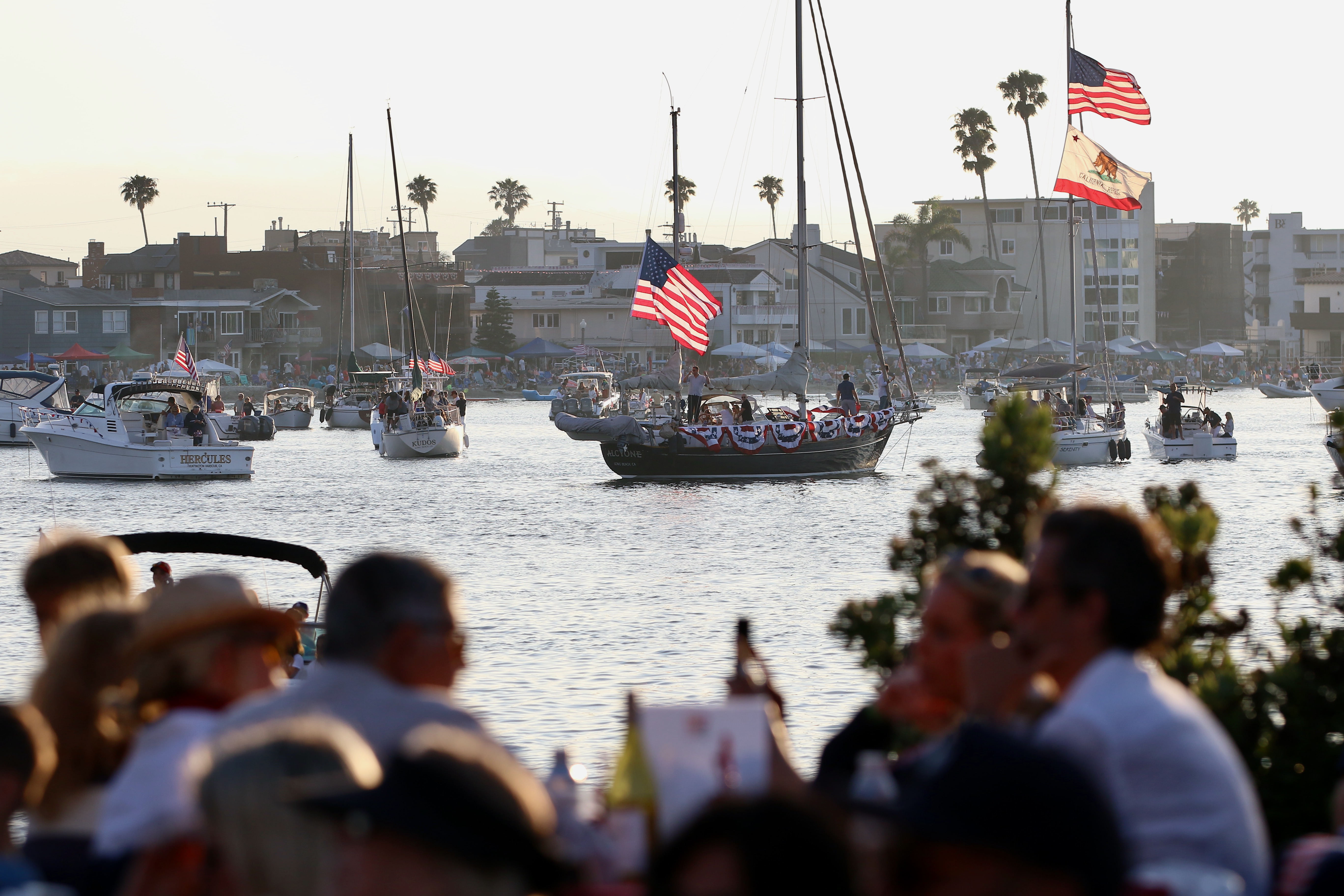 Boats fill Alamitos Bay as revelers gather on land for...