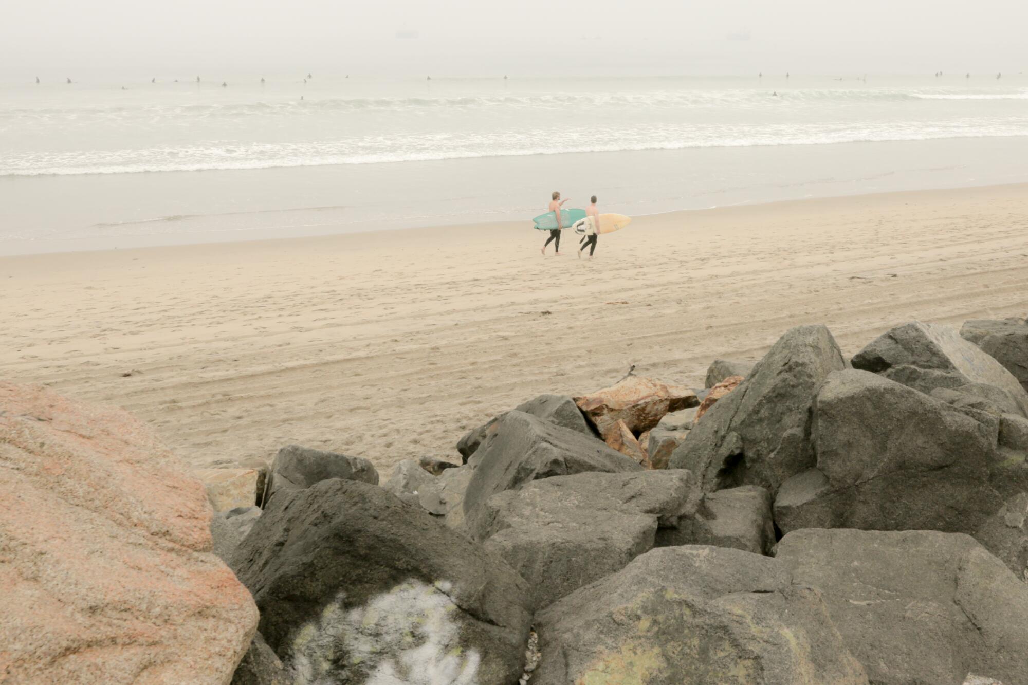 Surfers walking out to the break at El Porto.