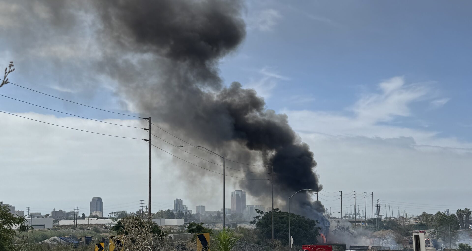 Large Trash Fire Near L.A. River Homeless Encampment Sends Smoke Across Long Beach