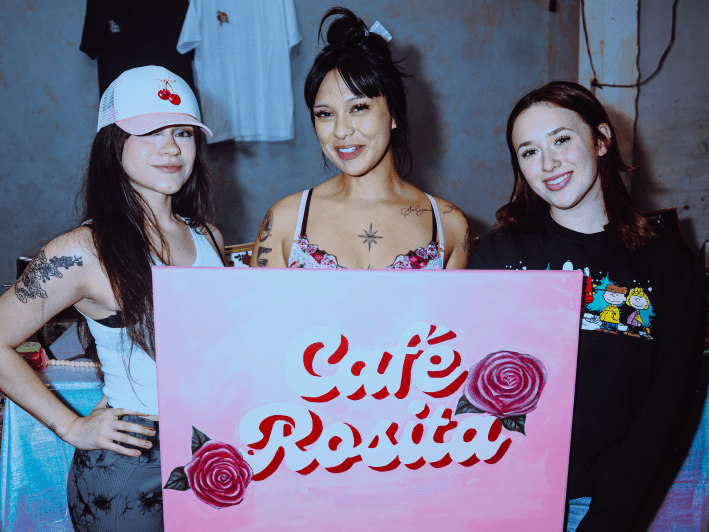 women pose with a sign