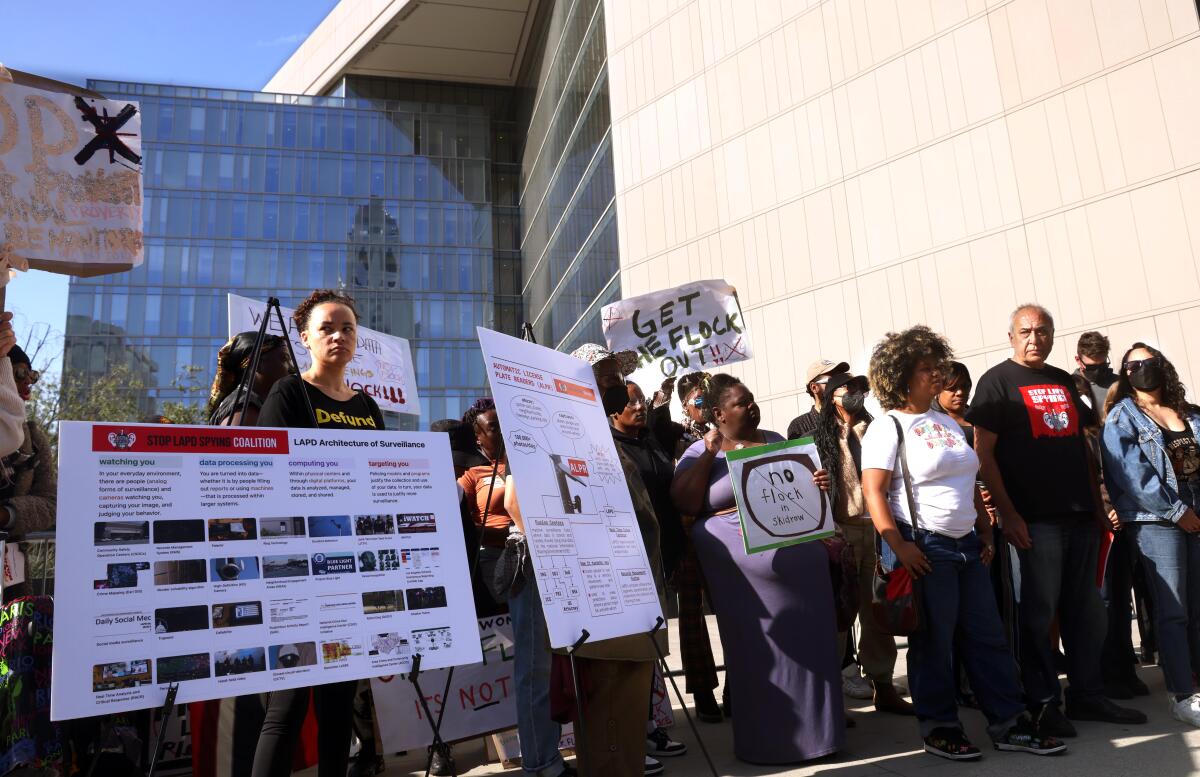 People holding large signs outside a building
