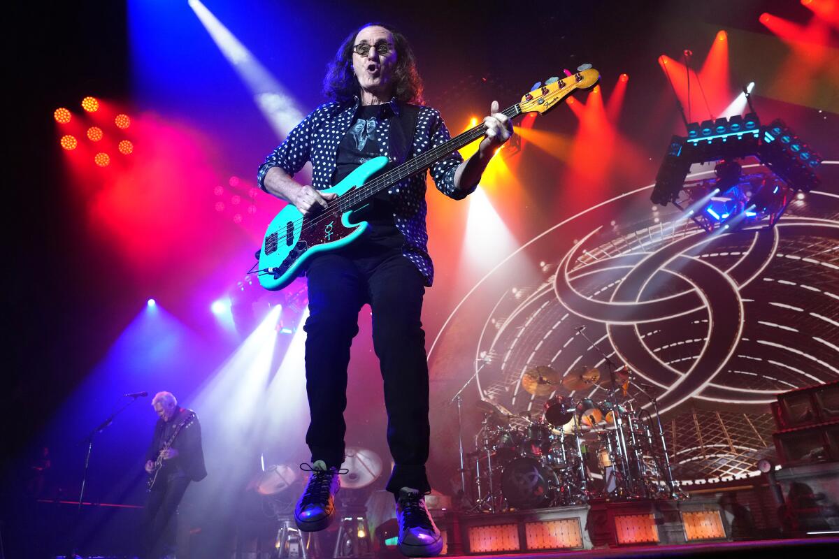 Geddy Lee plays as Rush performs at the Forum in Inglewood