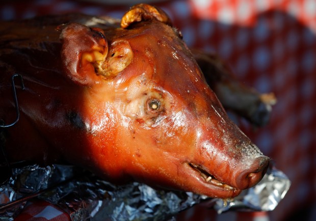 Delaney's Meat serves roasted pig along 18th Street near Raimondi Park during the Prescott Night Market in Oakland, Calif., on Thursday, July 11, 2024. (Jane Tyska/Bay Area News Group)