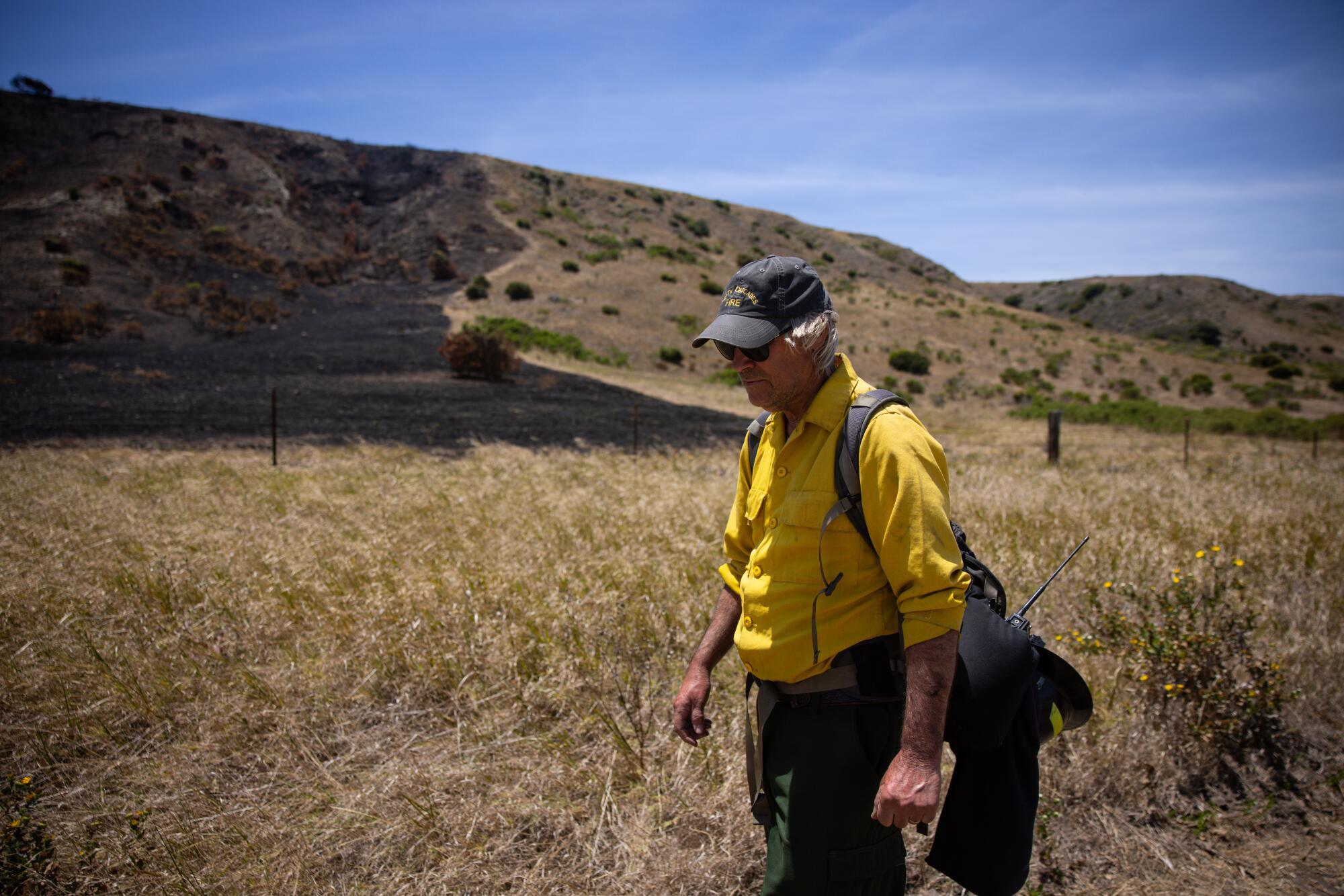 A walks a burned area.